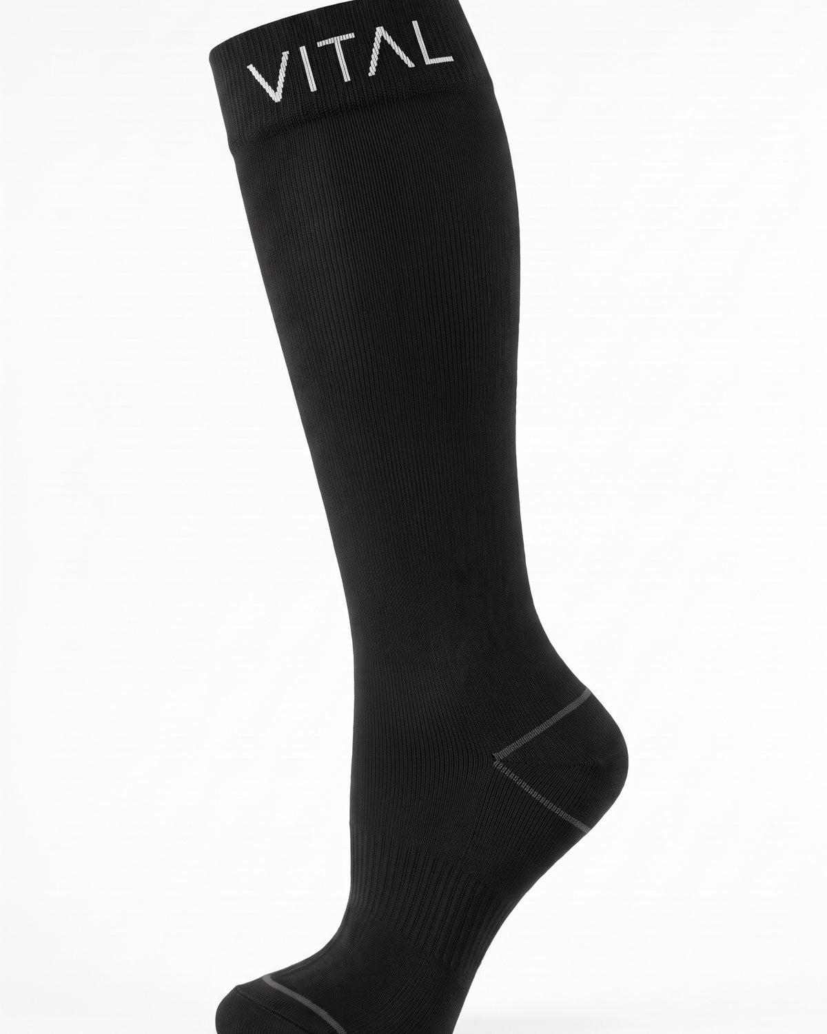 Black knee-high compression sock, fine ribbed knit and shaped heel, studio shot on white