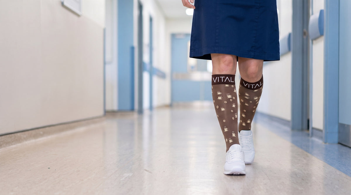 Espresso knee-high compression socks, mid-stride in white sneakers, corridor with pale blue door frames